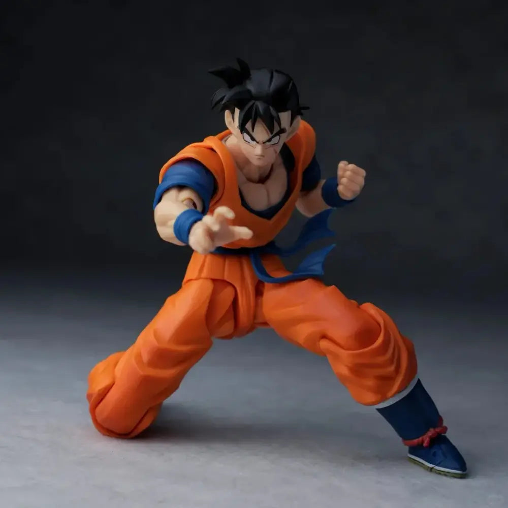 Dragon ball one-armed son gohan figure in orange and blue with articulated joints and fabric-like textures in dynamic pose