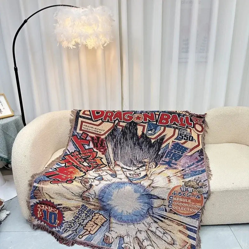A vibrant dragon ball textile blanket with cotton thread featuring goku in super saiyan form and bold red and blue letters