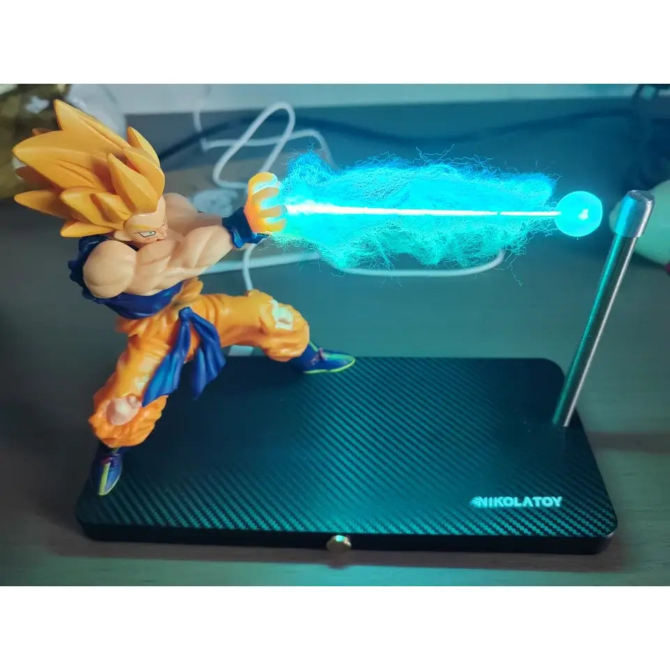 Golden-haired goku action figure in orange and blue gi posed mid-energy blast with glowing blue light in dragon ball night light