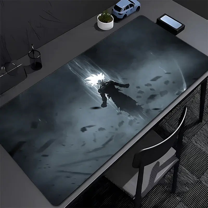 Black and gray dragon ball z goku gaming mouse pad with super saiyan goku illustration on a dark smoky desk mat