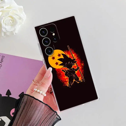 Black samsung ultra phone case featuring ball z goku holding staff against fiery orange sun with red stars back view
