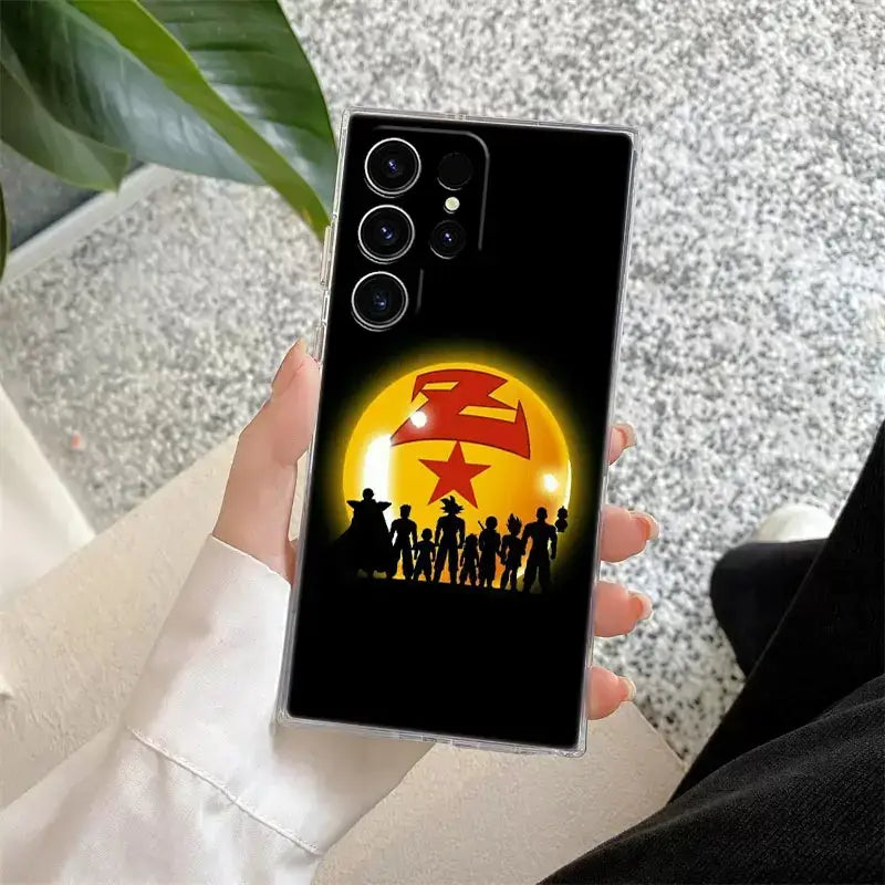 Back of clear samsung ultra phone case with black background glowing yellow dragon ball and ball z goku silhouettes