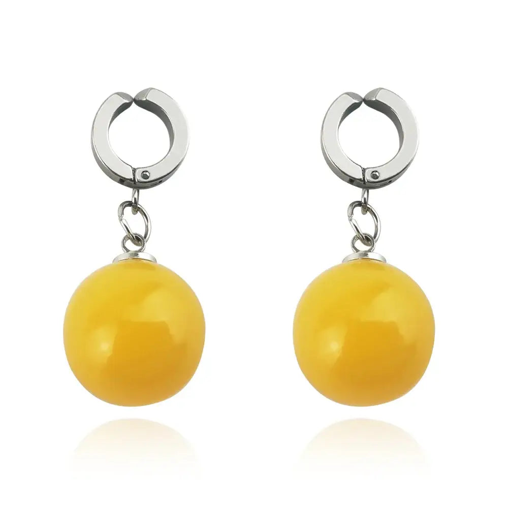 A pair of elegant yellow spherical dragon ball z potara cosplay accessory earrings with polished metallic hooks
