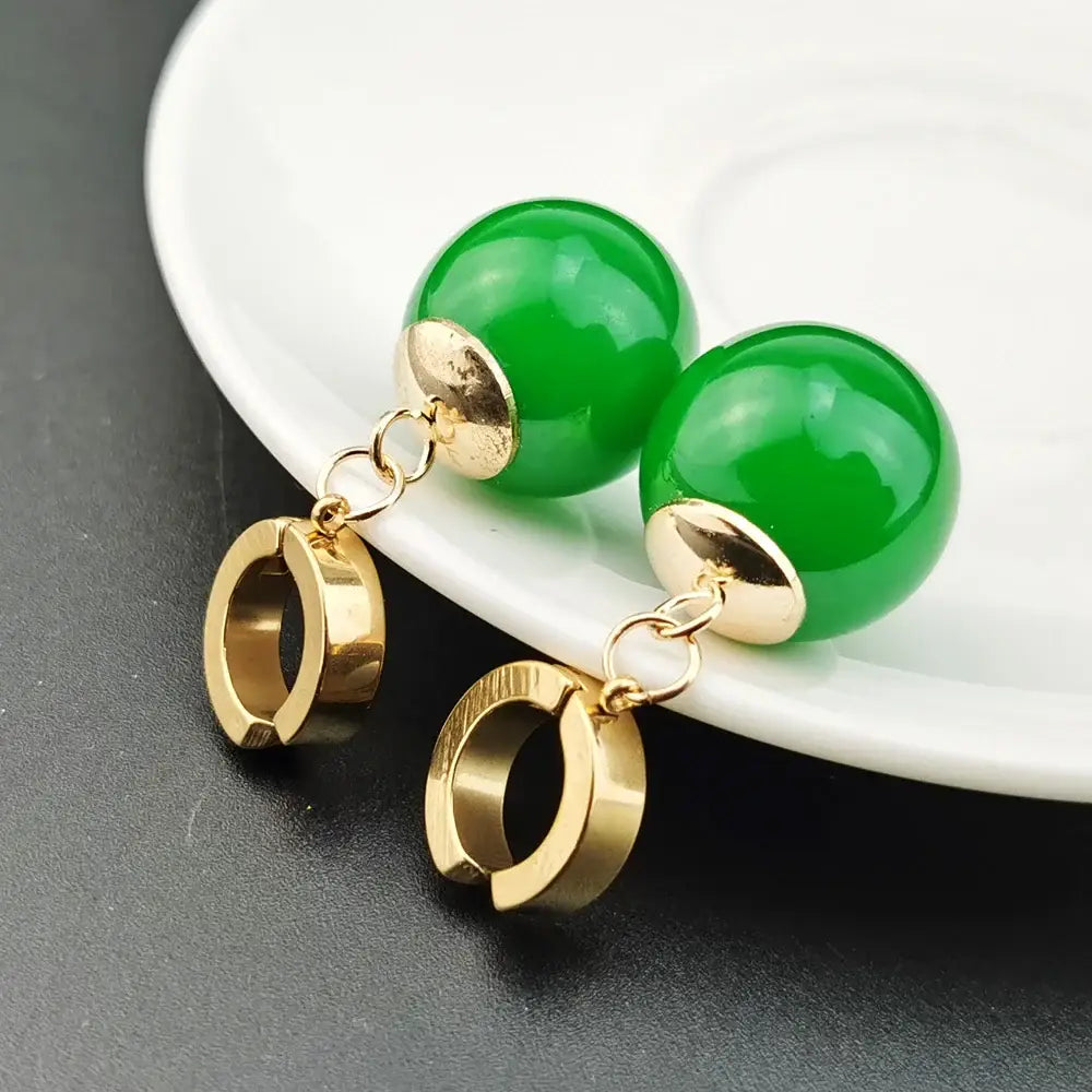 Vibrant green spherical jade ball z potara earrings with gold-toned metal accents and dangling hoop charms for cosplay