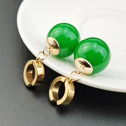 Vibrant green spherical jade ball z potara earrings with gold-toned metal accents and dangling hoop charms for cosplay