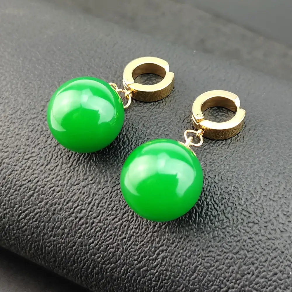 Vibrant green spherical jade dragon ball z potara earrings with gold-toned huggie hoop hooks cosplay accessory