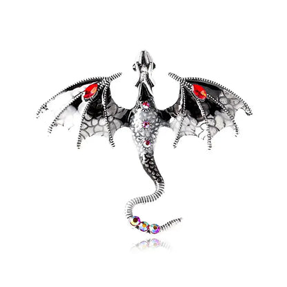 Silver dragon colorful metal brooch with black textured wings, red gemstone eyes, and rhinestones on curled tail lapel pin