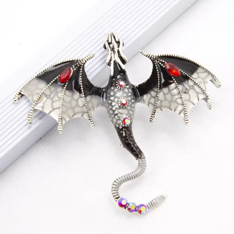 Silver dragon colorful metal brooch lapel pin with black enamel wings and red iridescent gemstone accents