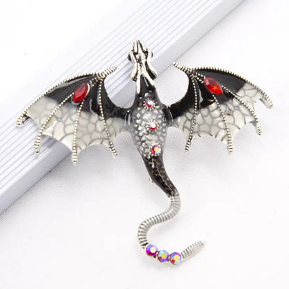 Silver dragon colorful metal brooch lapel pin with black enamel wings and red iridescent gemstone accents