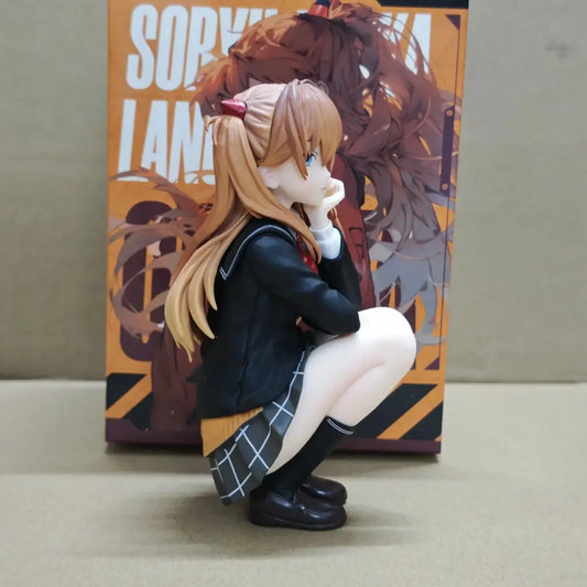 A detailed 15cm asuka langley soryu pvc figure in black school uniform crouching beside her box