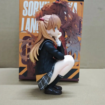 A detailed 15cm pvc statue of asuka langley soryu in a black school uniform crouching beside her box