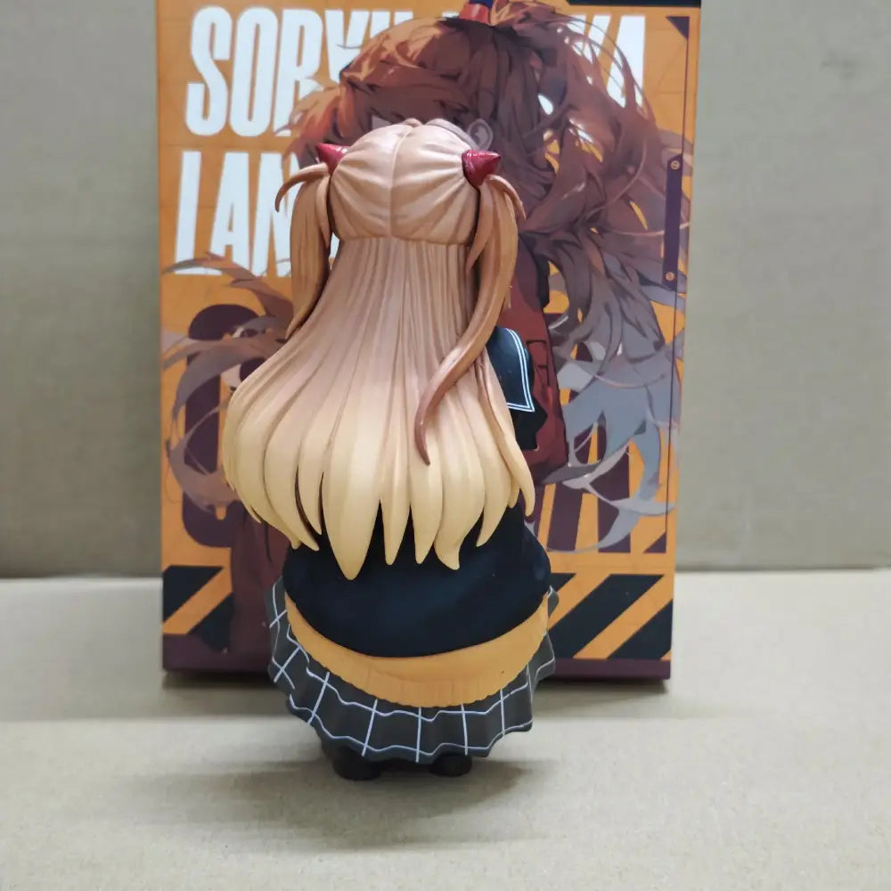 A detailed resin figurine of asuka langley soryu with blonde pigtails wearing a black grid skirt and yellow top in 15cm box
