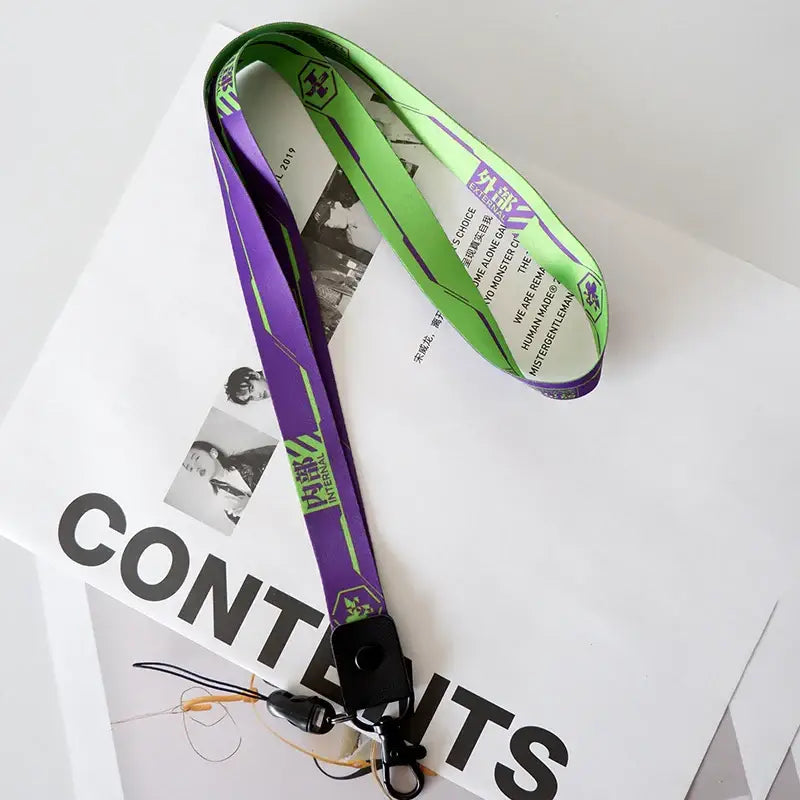 Evangelion EVA-01 phone lanyard neck strap in vibrant purple and neon green with black clip and bilingual text