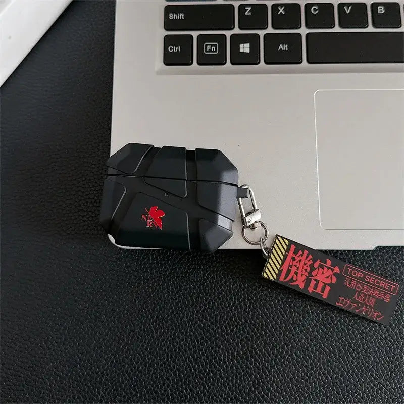 Black rugged silicone evangelion eva airpods case with red nerv logo and keychain featuring japanese top secret text
