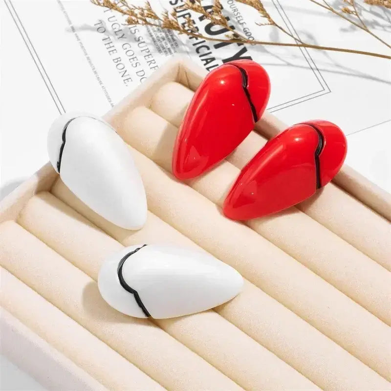 Evangelion rei ayanami hair clips featuring red and white cracked egg-shaped nail art pieces with black accent lines