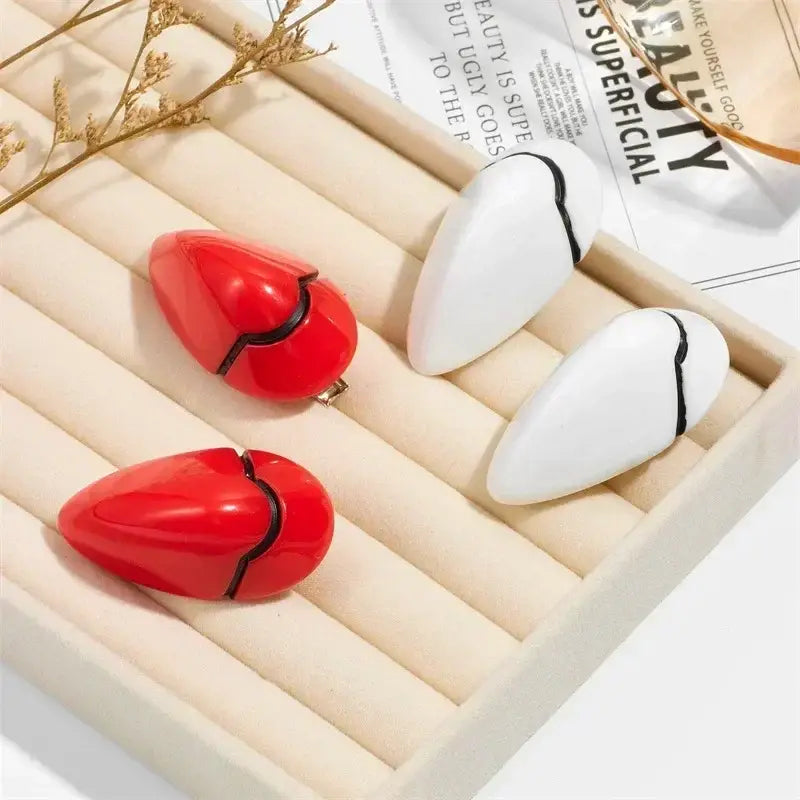 Evangelion rei ayanami hair clips with red and white heart-shaped design and black crack detailing for cosplay accessory