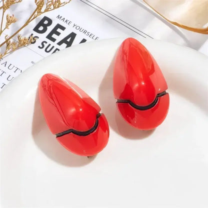 Vibrant red glossy teardrop shaped nail clippers with black hinge details for evangelion rei ayanami hair clips cosplay accessory