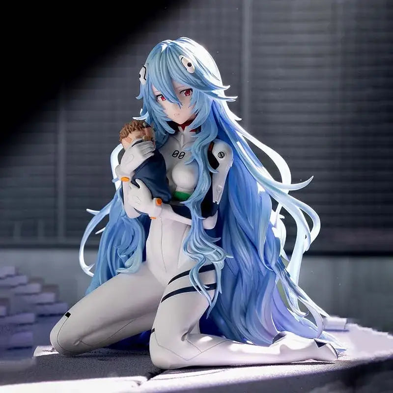 Detailed rei ayanami pvc statue in a white and black suit with blue hair in a kneeling pose holding a small doll