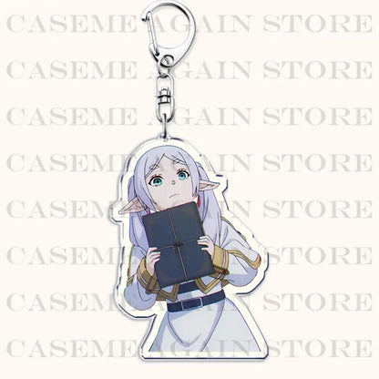 Clear acrylic keychain featuring silver-haired frieren holding a dark blue book as a bag charm from frieren beyond journey’s end