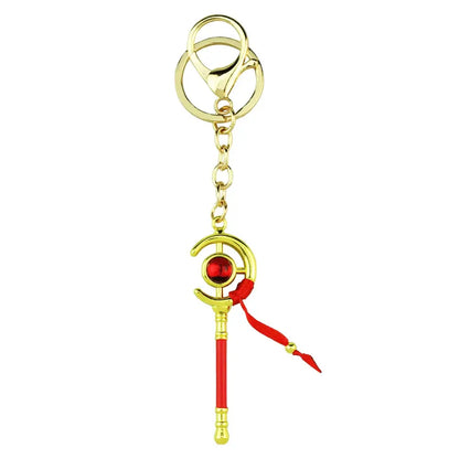 Gold-colored zinc alloy frieren frieren ring keychain with red and gold crescent wand and glowing orb charm