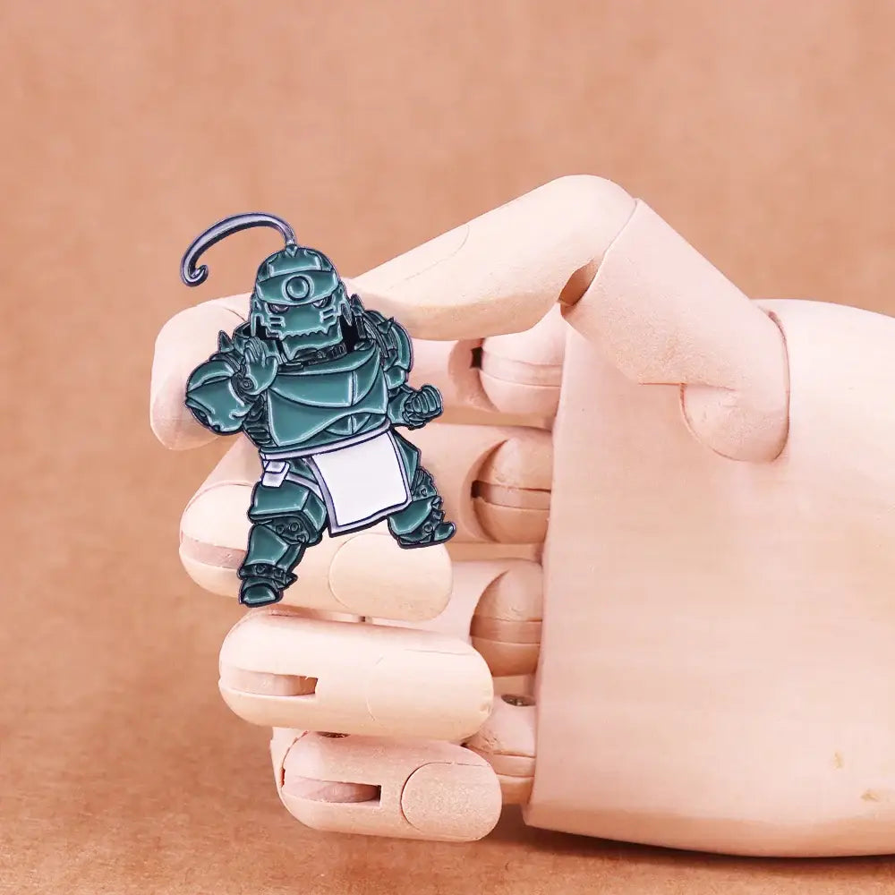 Teal metallic enamel alphonse elric pin badge featuring a stylized armored figure with white apron and curved antenna