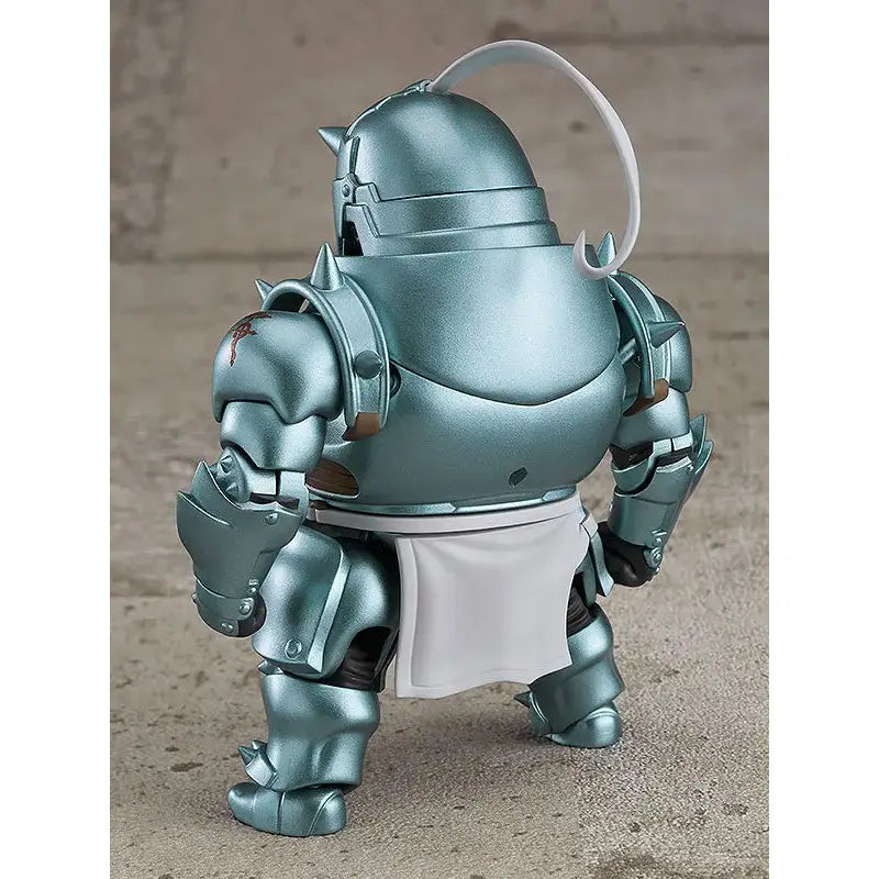A metallic teal alphonse elric fullmetal alchemist pvc figure with white apron and curved handle shown from the back