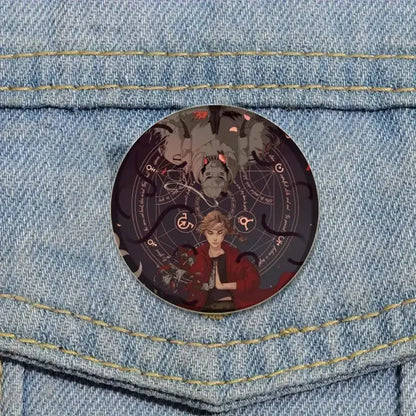 Circular glass brooch pin featuring an anime-style fullmetal alchemist character in red with occult symbols background