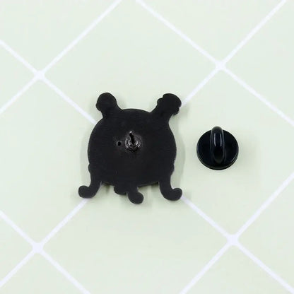 Black enamel fullmetal alchemist dwarf in the flask lapel pin shaped like a cartoonish octopus with short tentacles