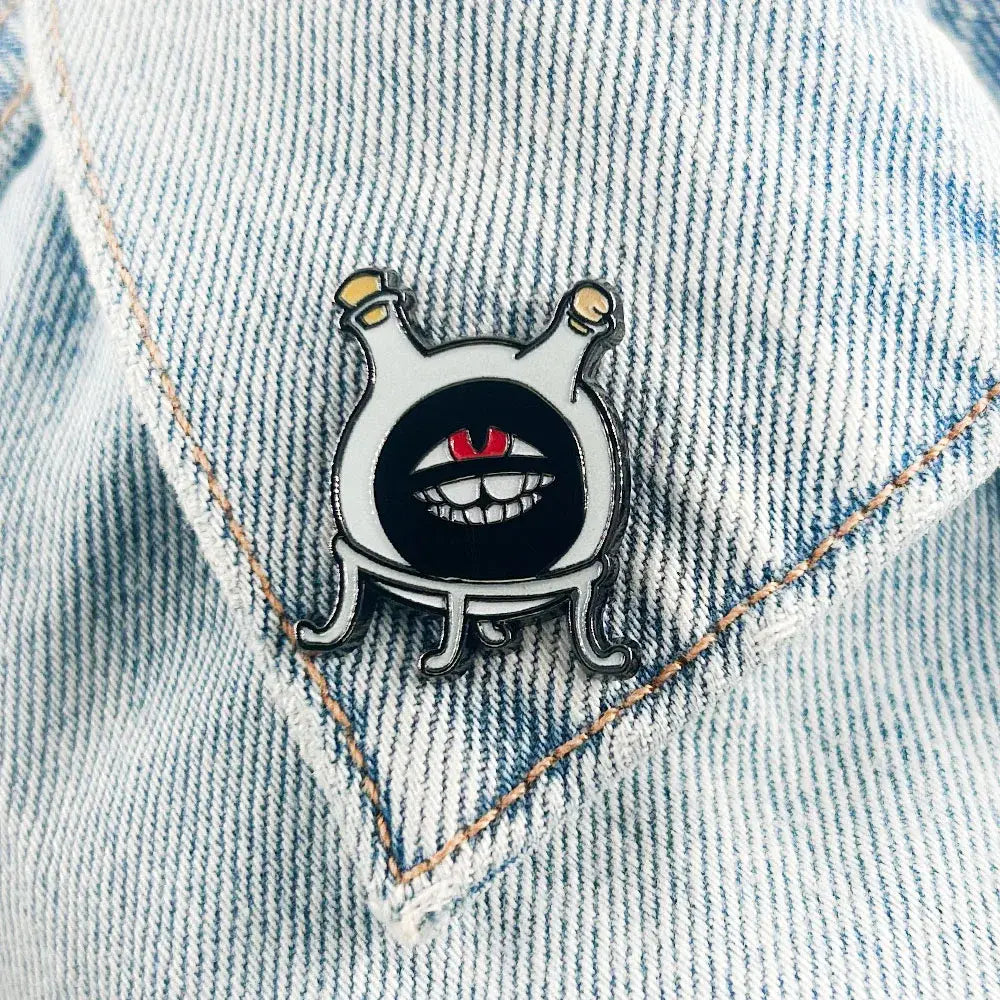 Fullmetal alchemist dwarf white enamel flask lapel pin featuring a cartoonish creature with black eyes and red pupils