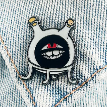 White enamel fullmetal alchemist dwarf flask lapel pin featuring a cartoon creature with red eyes and yellow antennae
