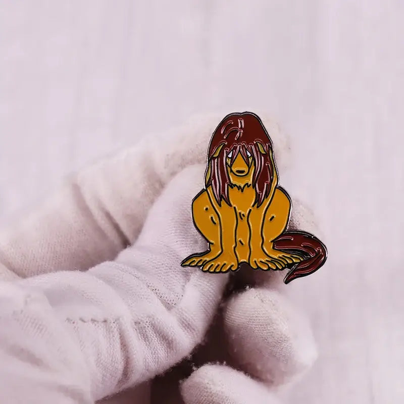 Vibrant orange and red enamel pin featuring a stylized lion mane design from fullmetal alchemist edward elric collection