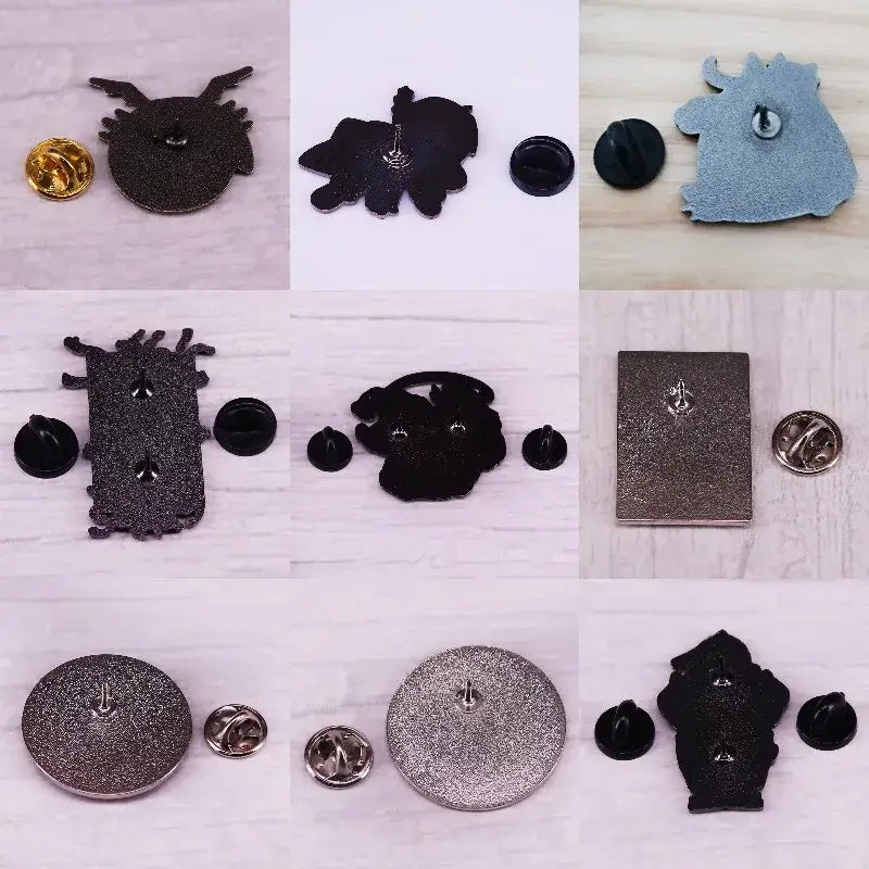 A collection of black silver and gold glittery edward elric enamel lapel pins featuring monsters and a phone design