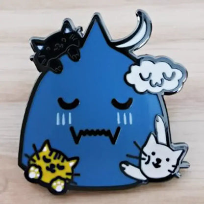Blue enamel lapel pin featuring sleepy triangular creature and cats inspired by alchemist edward elric design