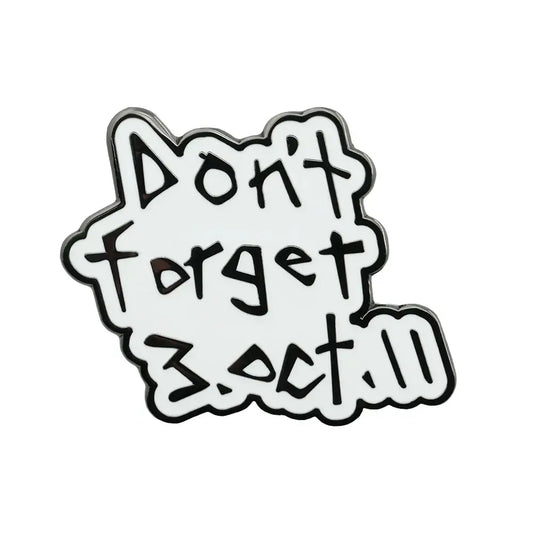 White enamel pin with black outlined text reading dont forget 3.oct.11 in playful font fullmetal alchemist edward elric badge