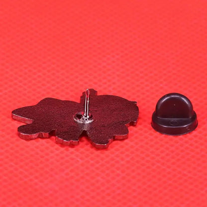 Dark red enamel pin shaped like a stylized flower with metallic edges and silver fastener fullmetal alchemist edward elric