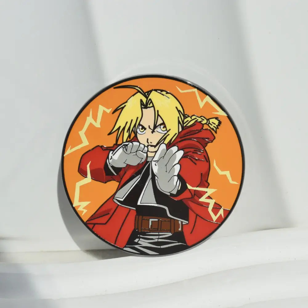 Circular metal badge enamel pin featuring fullmetal alchemist edward elric with blonde hair and red coat