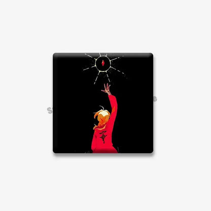 Black square lapel brooch featuring edward elric in red reaching toward a glowing sun symbol from fullmetal alchemist