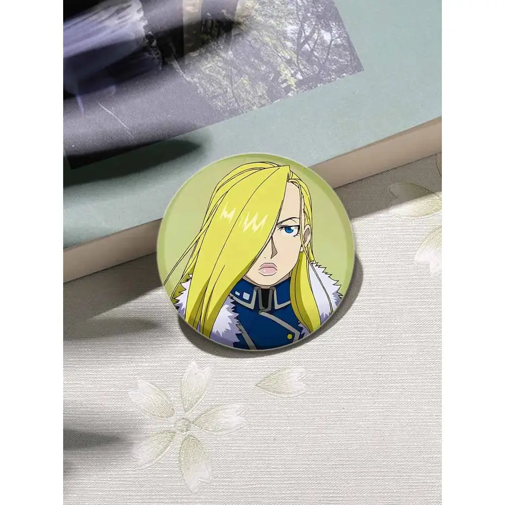 Circular fullmetal alchemist enamel brooch featuring an anime character with blonde hair and blue eyes in dark blue outfit