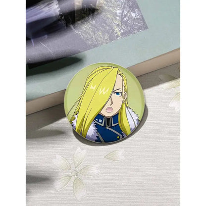 Circular fullmetal alchemist enamel brooch featuring an anime character with blonde hair and blue eyes in dark blue outfit