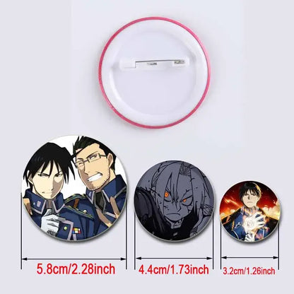 Three handmade fullmetal alchemist enamel brooches with pink-rimmed backings featuring different designs and sizes