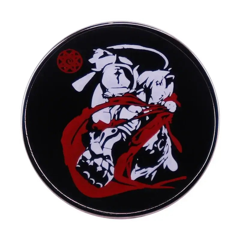 Black circular metal brooch badge featuring a stylized white and red fullmetal alchemist enamel pin design with intricate linework