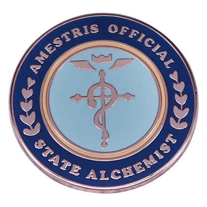 Blue and silver enamel fullmetal alchemist brooch badge featuring caduceus symbol and amestris official state alchemist text
