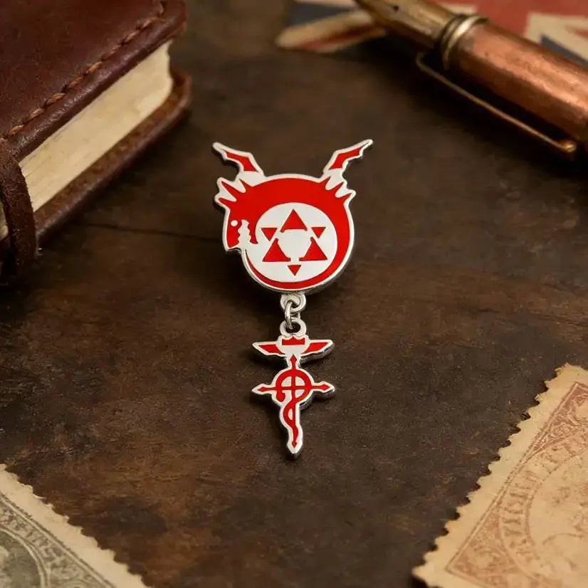 Red and silver enamel pin featuring fullmetal alchemist flamel homunculus logo with dragon head and red cross charm