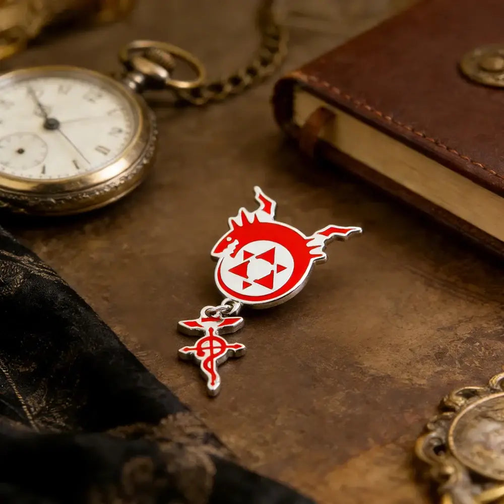 Red and silver enamel pin featuring fullmetal alchemist flamel homunculus logo with stylized dragon head and inverted cross