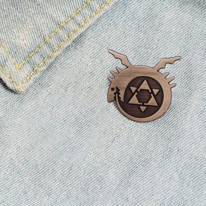 Wooden fullmetal alchemist enamel pin featuring a stylized dragon and geometric emblem metal badge design