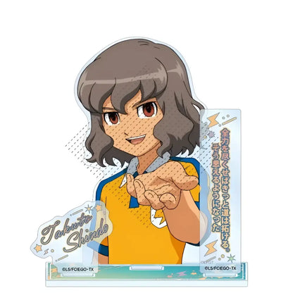 Clear acrylic stand featuring anime character asuto inamori with brown wavy hair in yellow and blue sports jersey