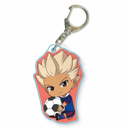Chibi-style acrylic keychain of blonde anime soccer player asuto inamori in blue uniform holding black and white ball