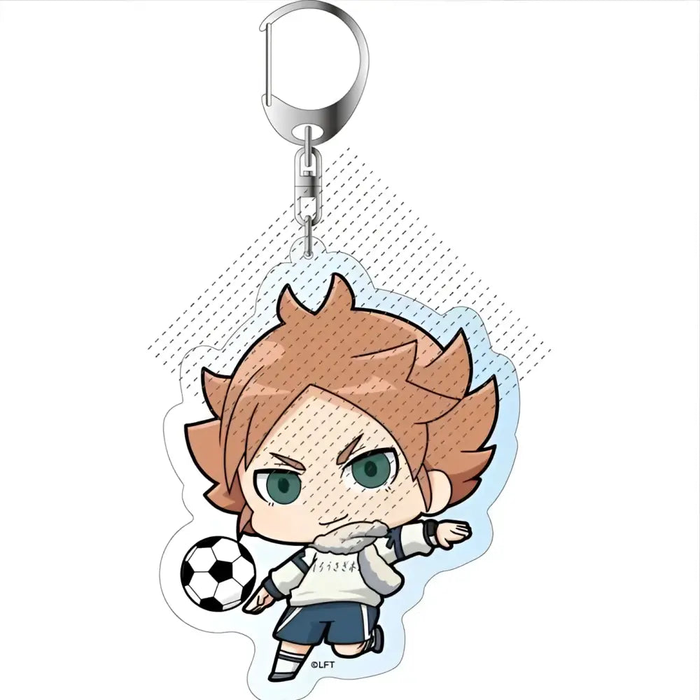 Chibi-style acrylic keychain featuring a brown-haired green-eyed character in white shirt and blue shorts holding a soccer ball
