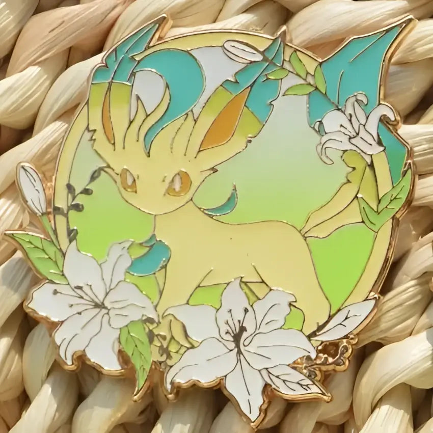 Yellow and teal enamel pin featuring a stylized eevee surrounded by lilies and foliage, gengar anime elf brooch
