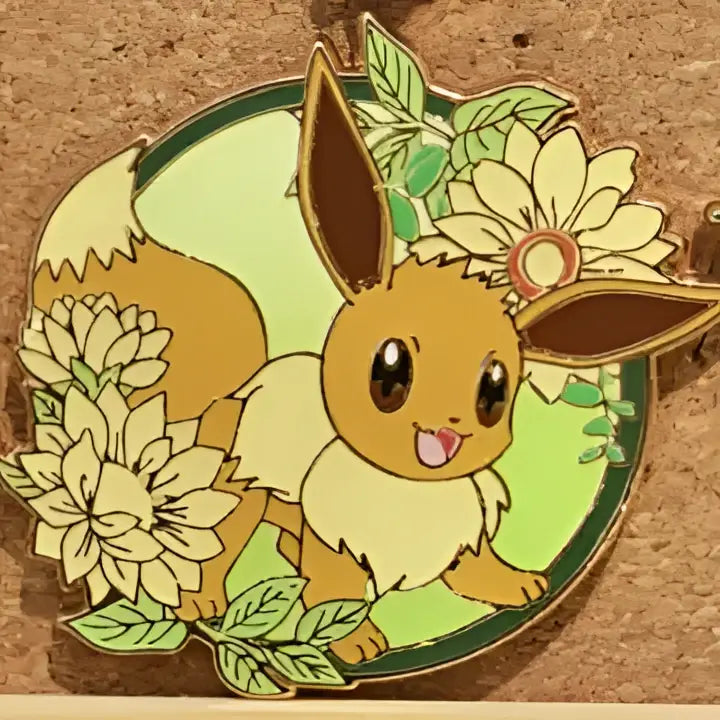 A cheerful tan eevee enamel pin with brown ears and white fur surrounded by cream flowers for gengar anime elf fans